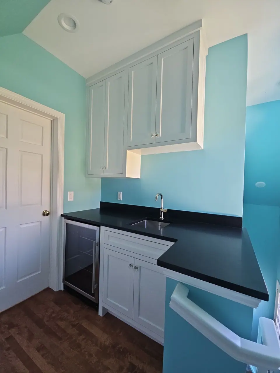 Teal accent wall in a laundry room