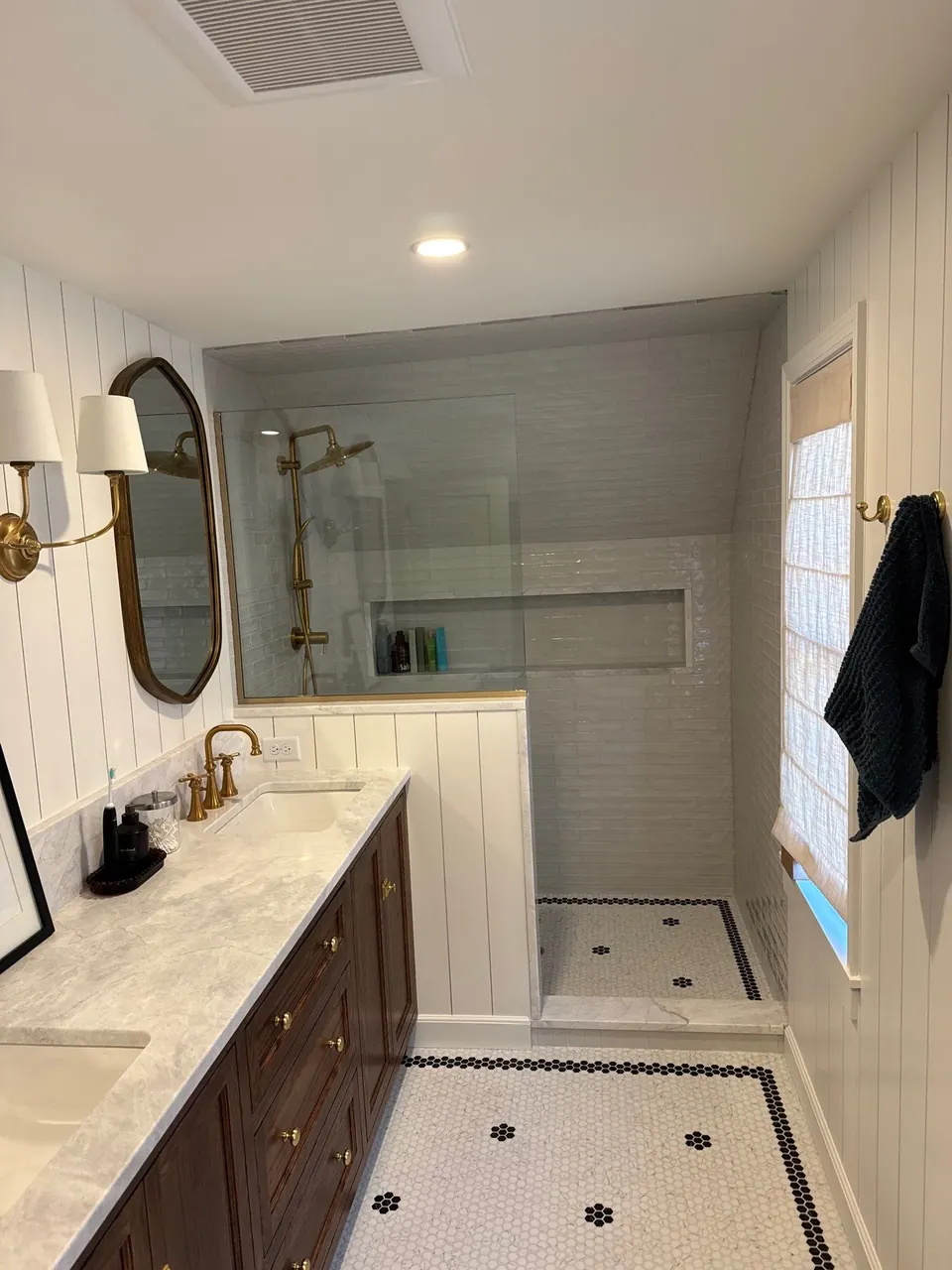 Bathroom with tiled shower and painted walls
