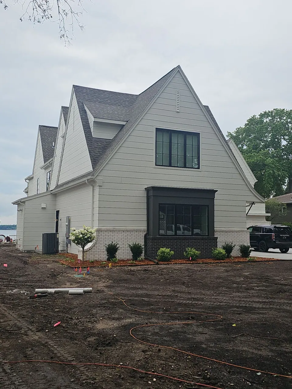 Modern farmhouse with black windows and white siding