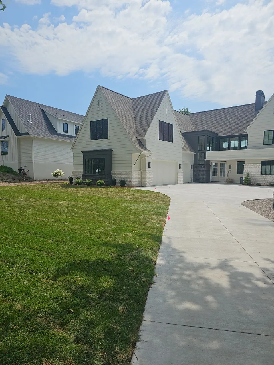 White custom home with a long driveway
