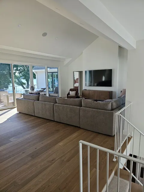 Living room fireplace with built-in shelving on both sides, all painted white, walls freshly finished.
